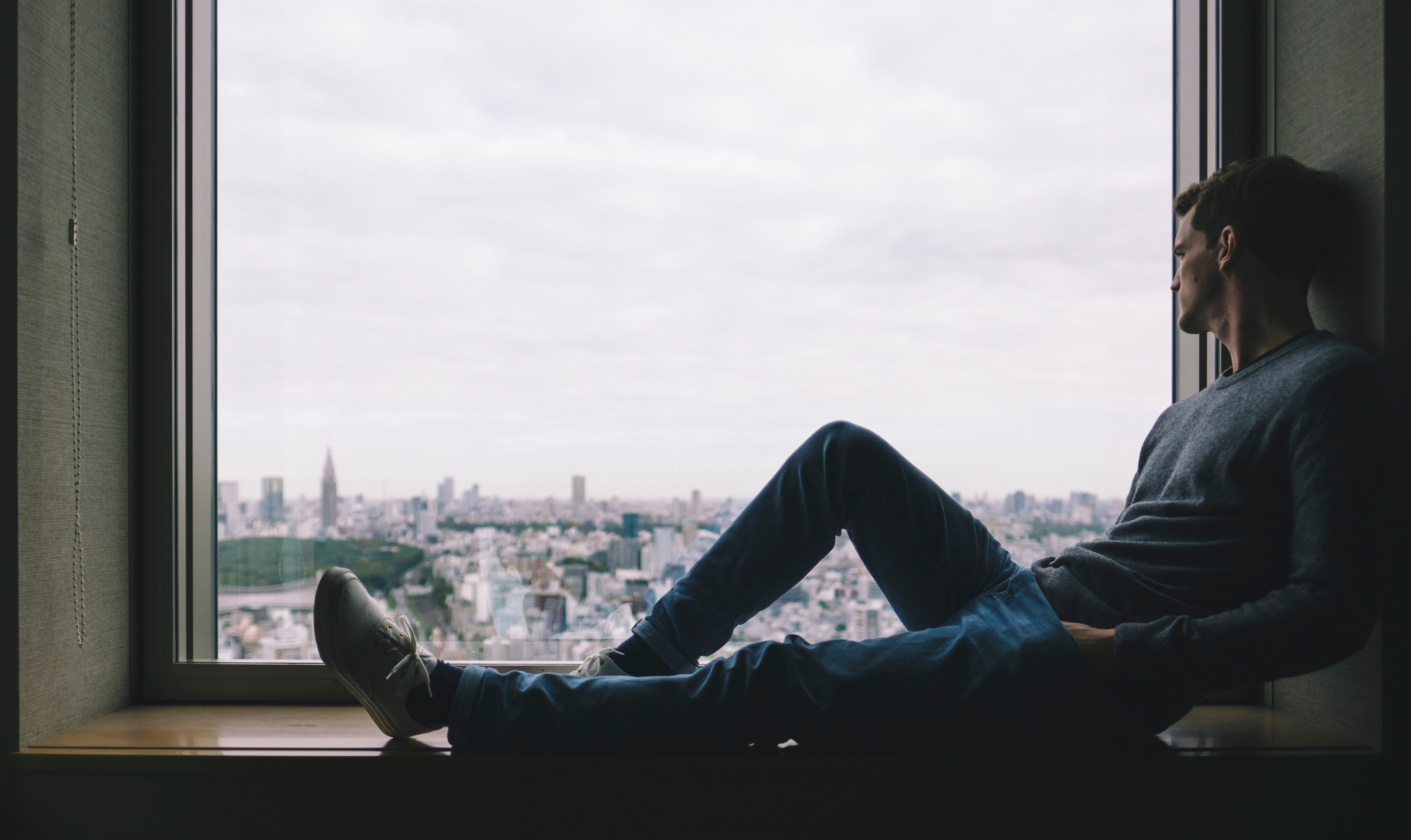 Man Relaxing by the Window